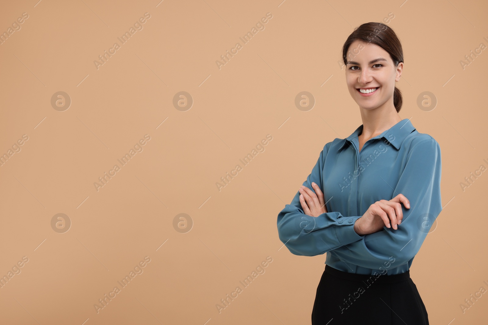 Photo of Happy secretary with crossed arms on beige background, space for text