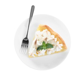 Photo of Piece of delicious lemon meringue pie with plate and fork isolated on white, top view