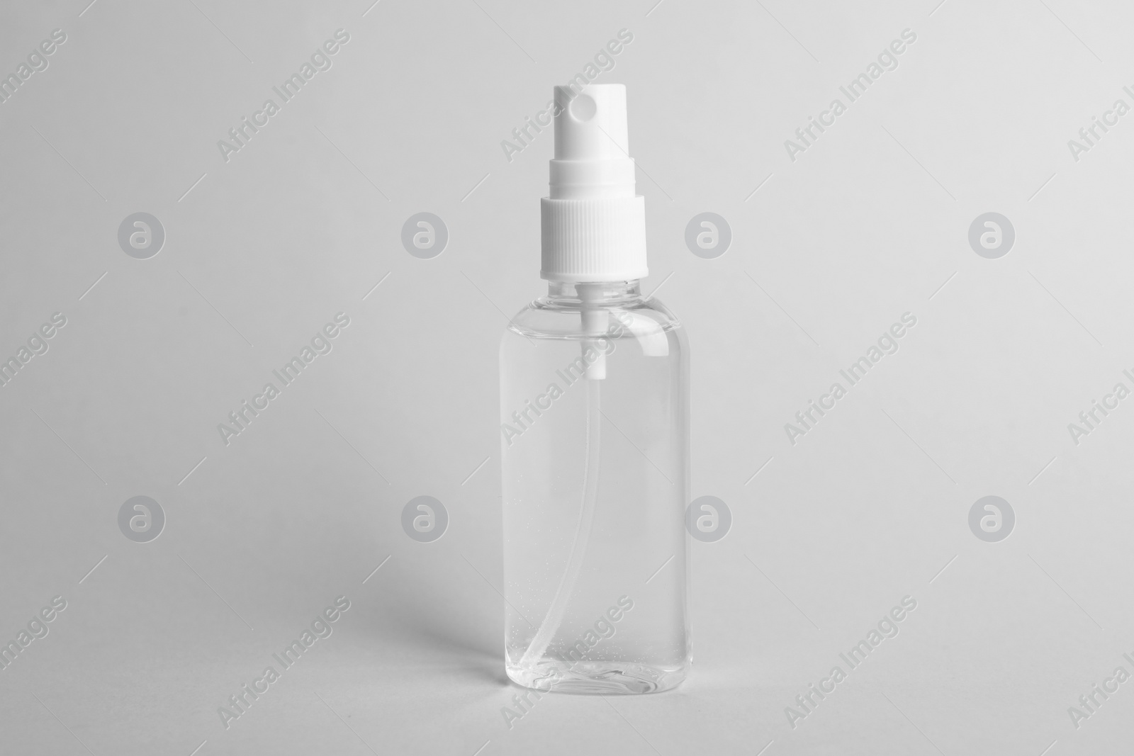 Photo of Spray bottle with antiseptic on light grey background