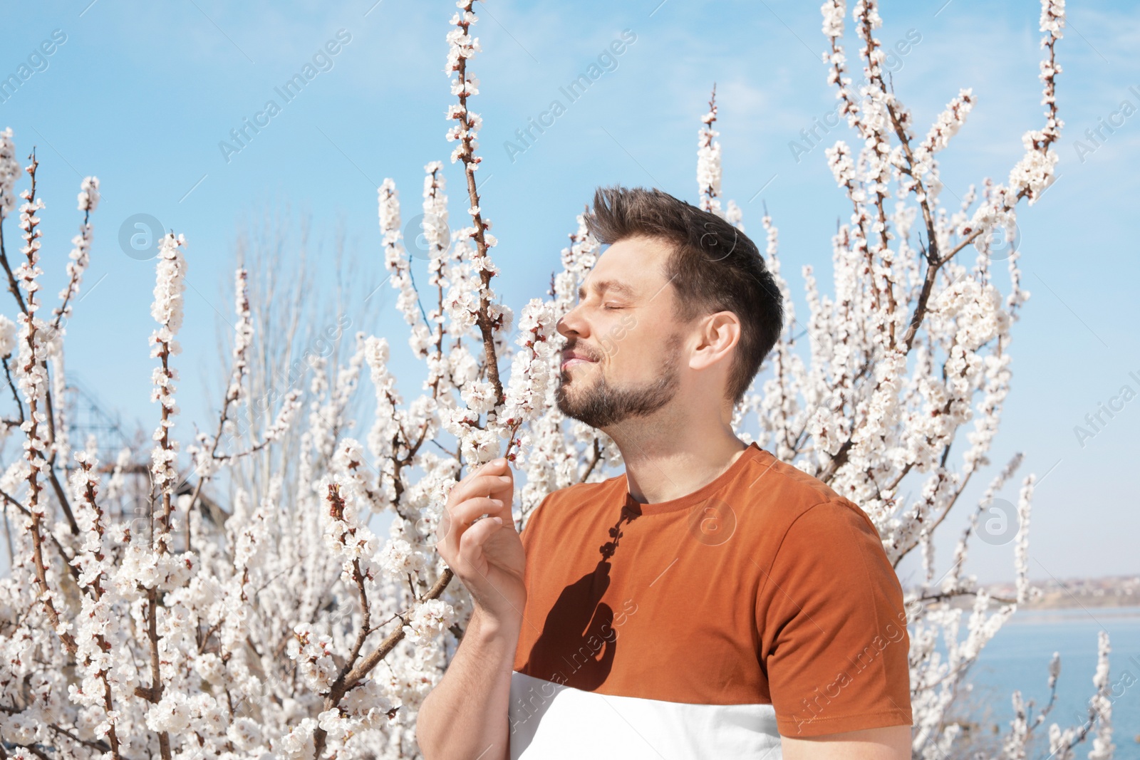 Photo of Happy healthy man enjoying springtime outdoors, space for text. Allergy free concept