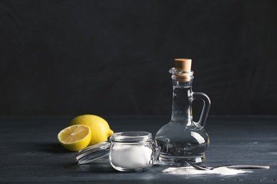 Photo of Composition with vinegar, lemons and baking soda on table