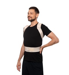 Photo of Handsome man with orthopedic corset on white background