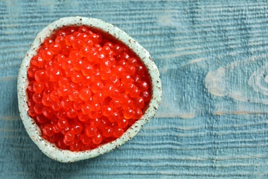 Ceramic bowl with delicious red caviar on table