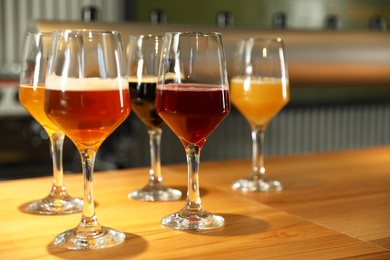 Different sorts of beer on wooden bar counter