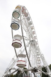 Photo of Large white observation wheel against sky, low angle view