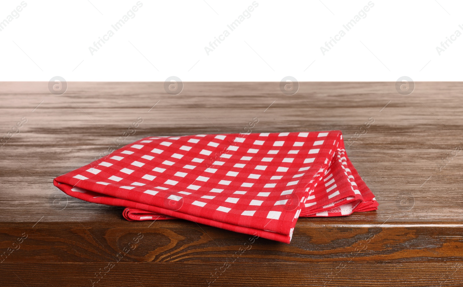 Photo of Checkered tablecloth on wooden table against white background