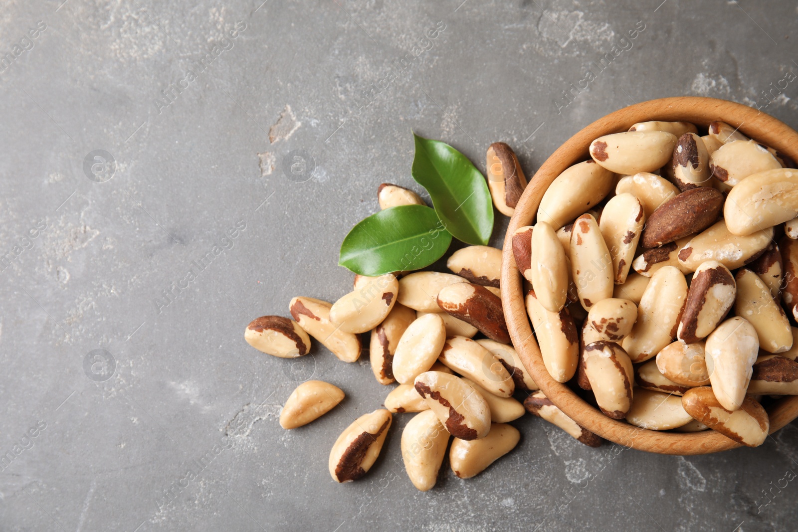 Photo of Flat lay composition with Brazil nuts and space for text on grey background