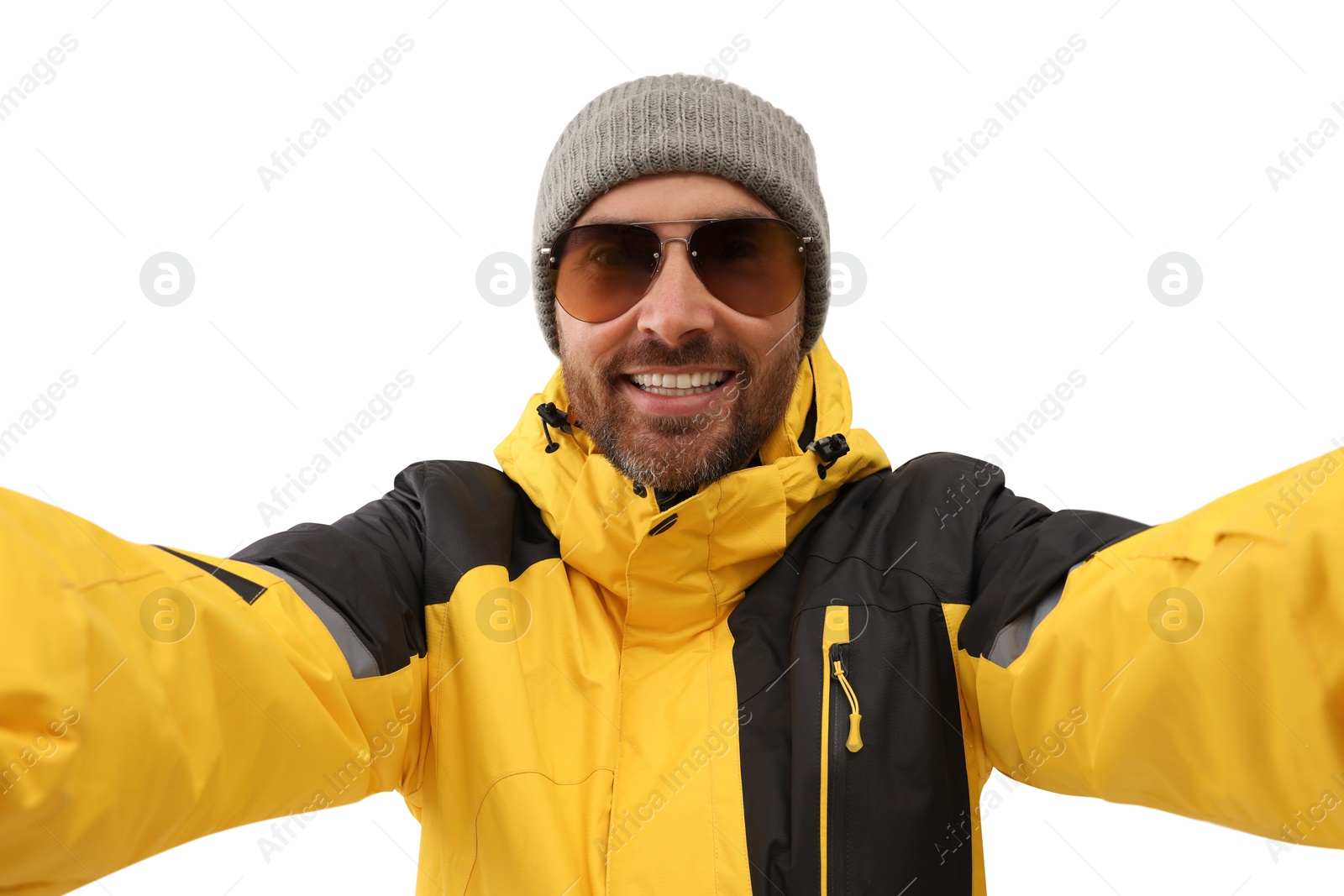 Photo of Smiling man in hat and sunglasses taking selfie on white background