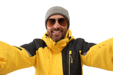 Photo of Smiling man in hat and sunglasses taking selfie on white background