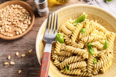 Plate of delicious basil pesto pasta served for dinner on table