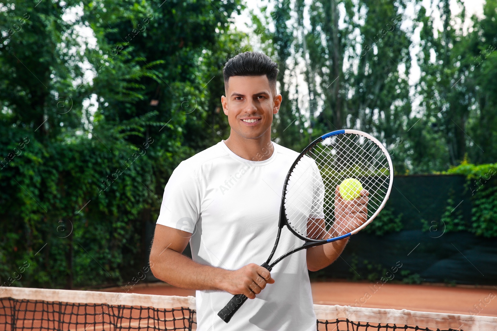 Photo of Man with racket and ball on tennis court