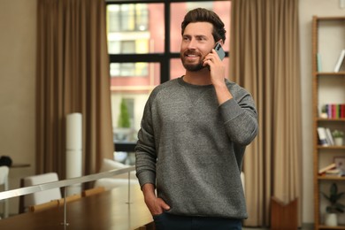 Handsome man talking on phone in cafe