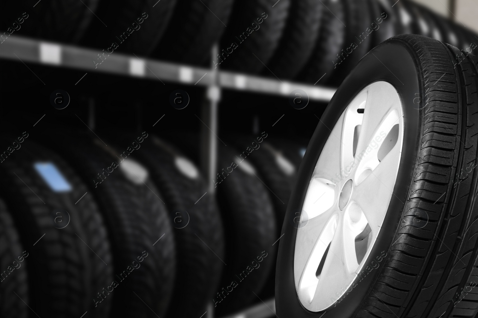 Image of Black car tire in auto store, closeup