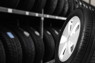 Image of Black car tire in auto store, closeup