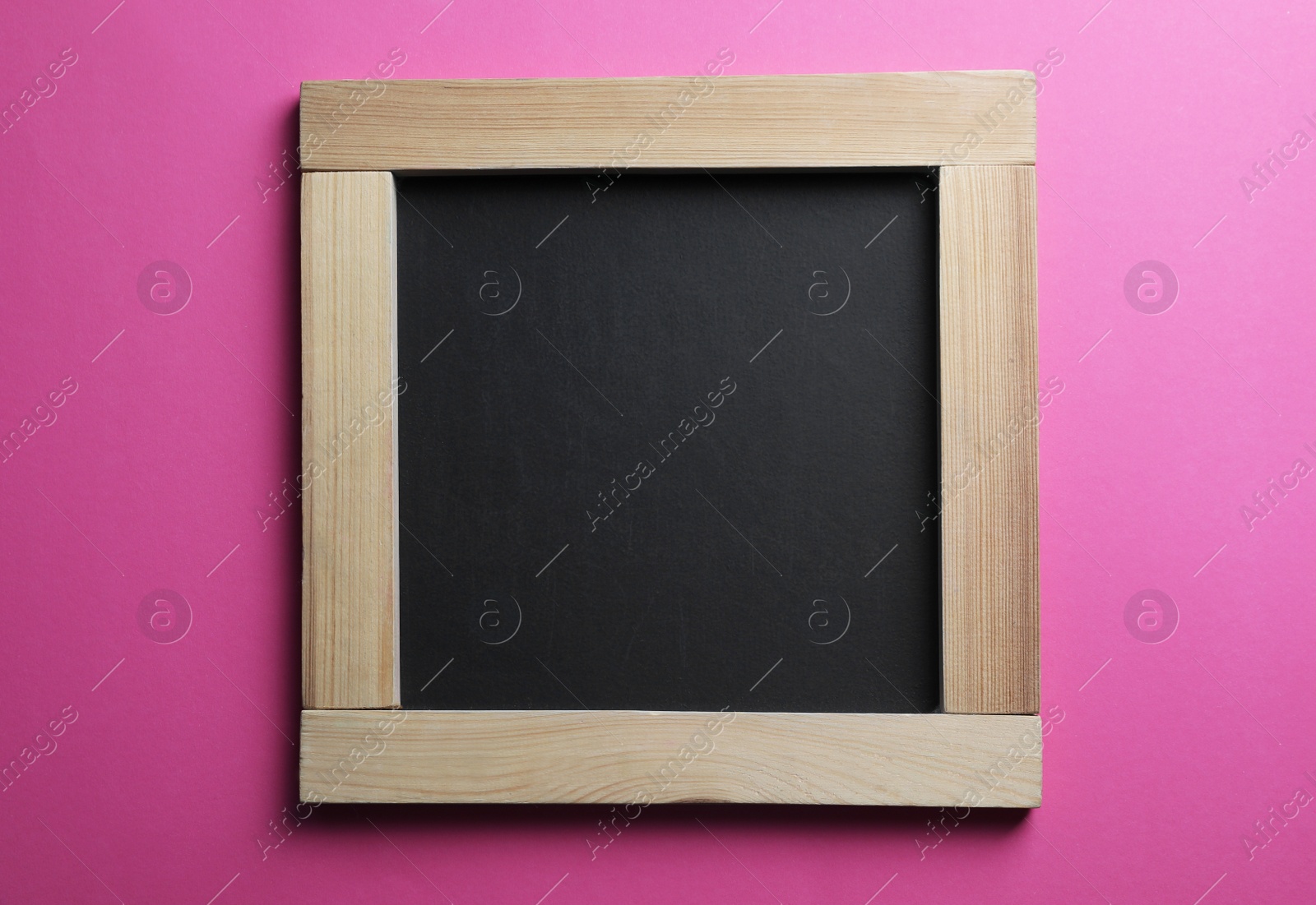 Photo of Blank chalkboard on pink background, top view. Space for text