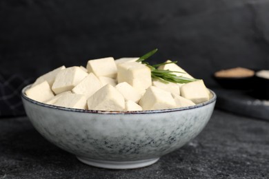 Delicious tofu with rosemary on grey table, closeup