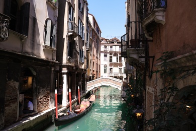 VENICE, ITALY - JUNE 13, 2019: Gondola on city canal. Gondola is traditional Venetian rowing boat