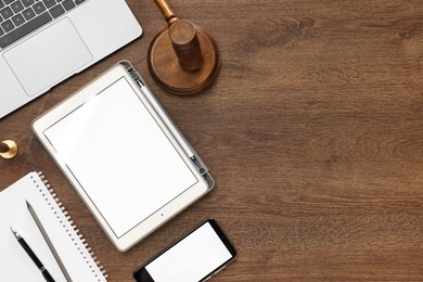 Photo of Flat lay composition with modern tablet on wooden table. Space for text