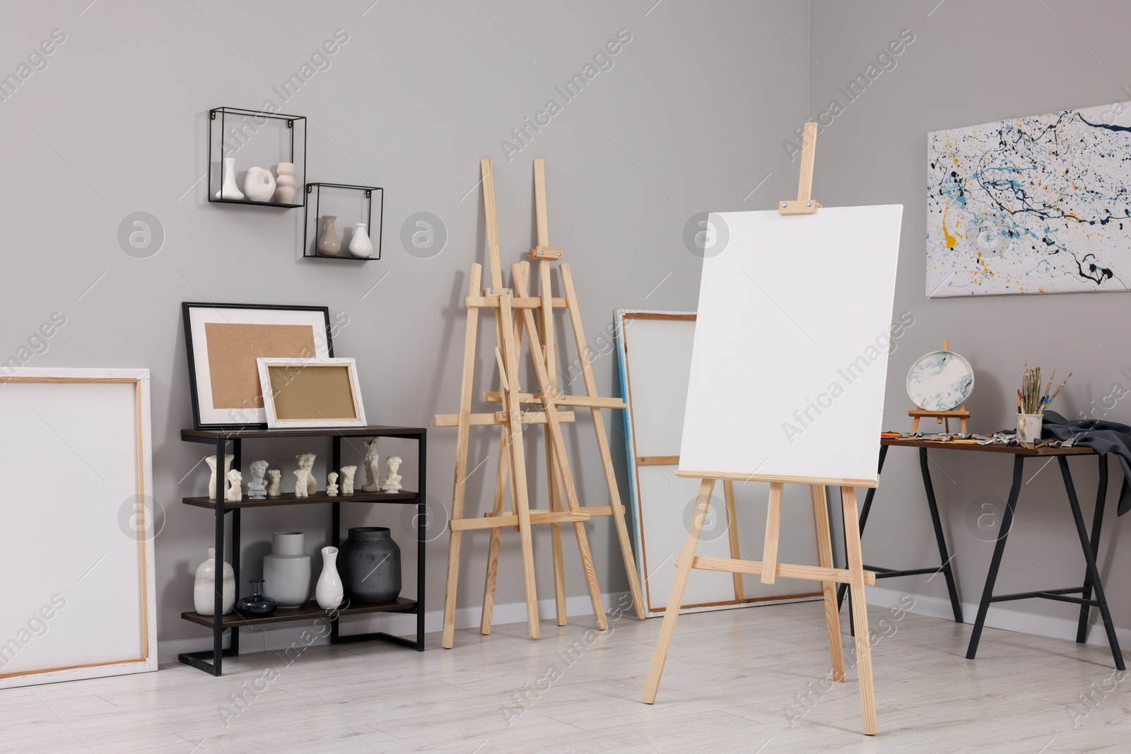 Photo of Artist's studio with easels, canvases and painting supplies