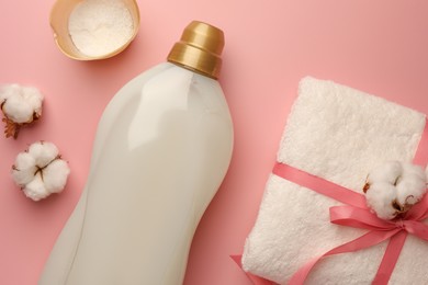Photo of Flat lay composition with bottle of fabric softener on pink background