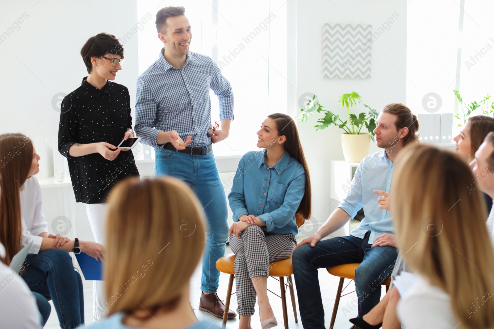 Photo of Young people having business training in office