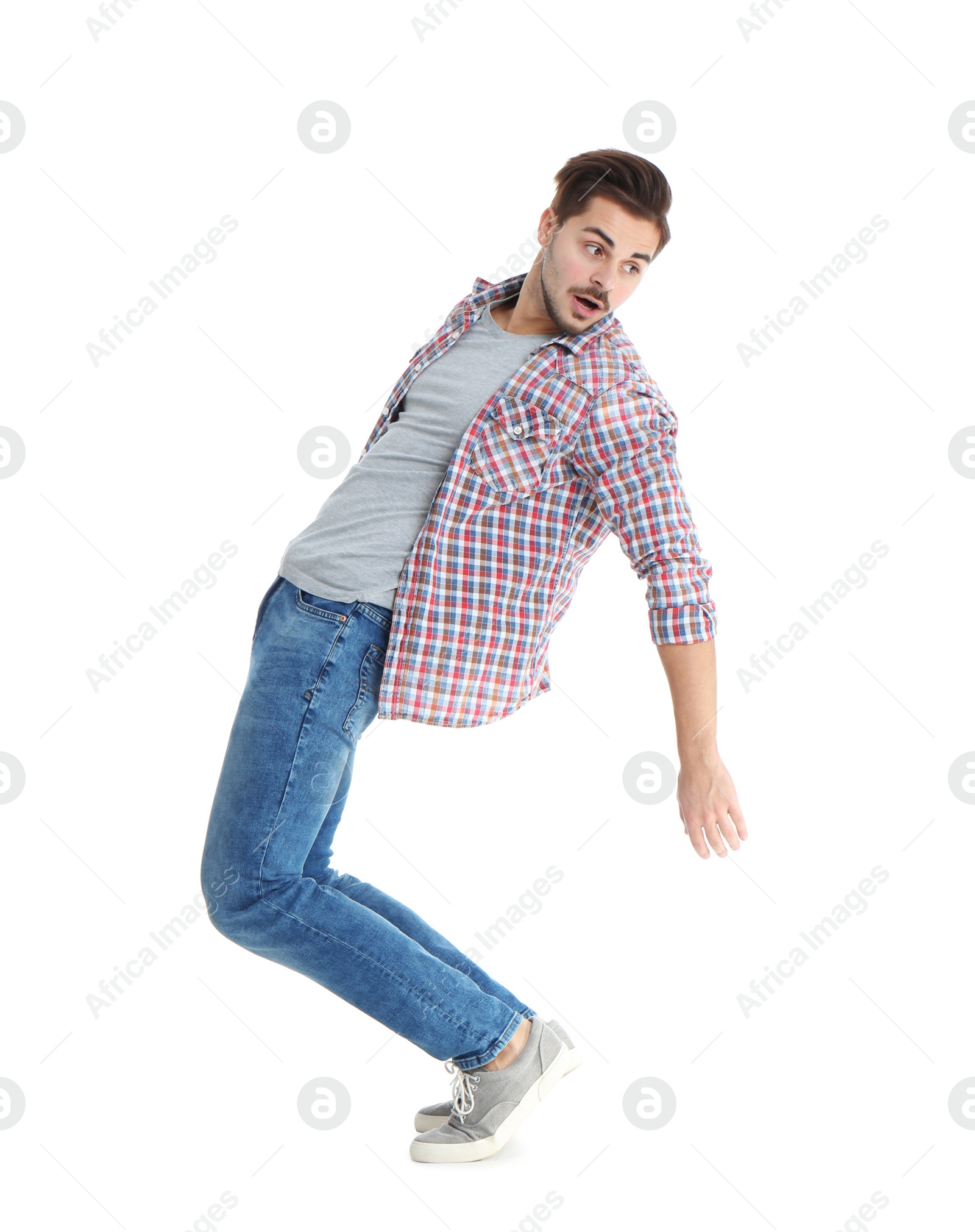 Photo of Young man attracted to magnet on white background