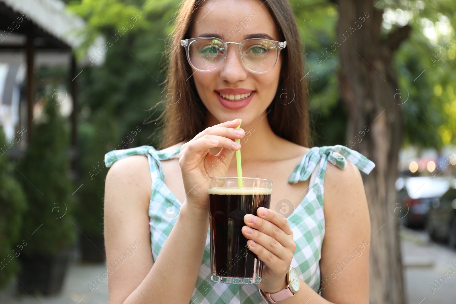 Photo of Young woman with cold kvass outdoors. Traditional Russian summer drink