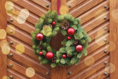 Beautiful Christmas wreath hanging on wooden door