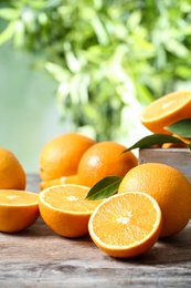 Ripe oranges on table against blurred background. Space for text