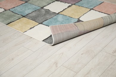 Soft carpet with pattern on white laminated floor indoors, space for text