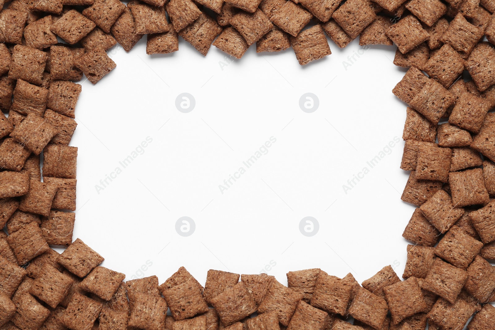 Photo of Frame of sweet crispy chocolate corn pads on white background, top view. Space for text