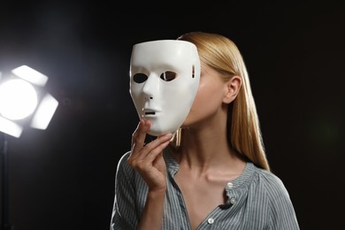 Photo of Professional actress with mask on stage in theatre
