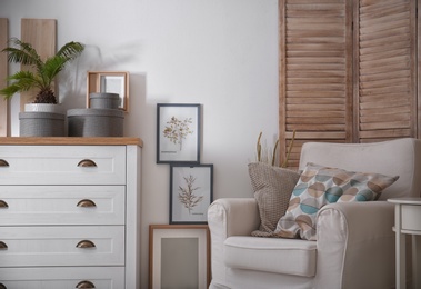 Photo of Cozy apartment with comfortable armchair near wall