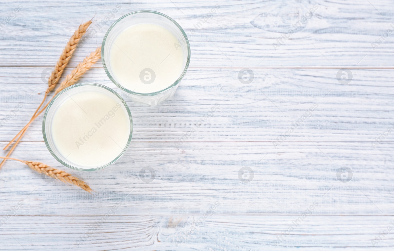 Photo of Glasses of milk on wooden table. Fresh dairy product