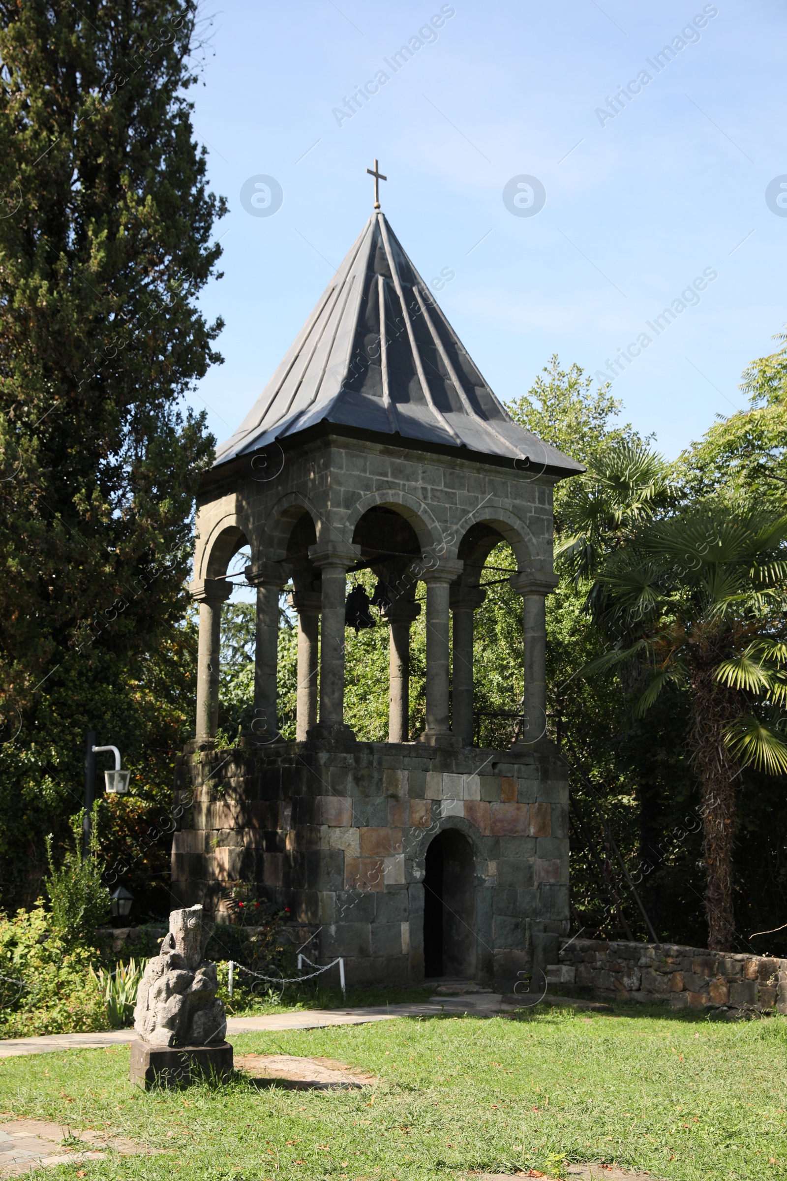 Photo of Exterior of beautiful bell tower in park on sunny day