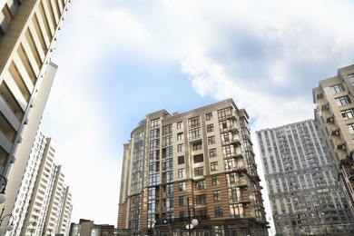 Modern buildings with tinted windows against sky. Urban architecture