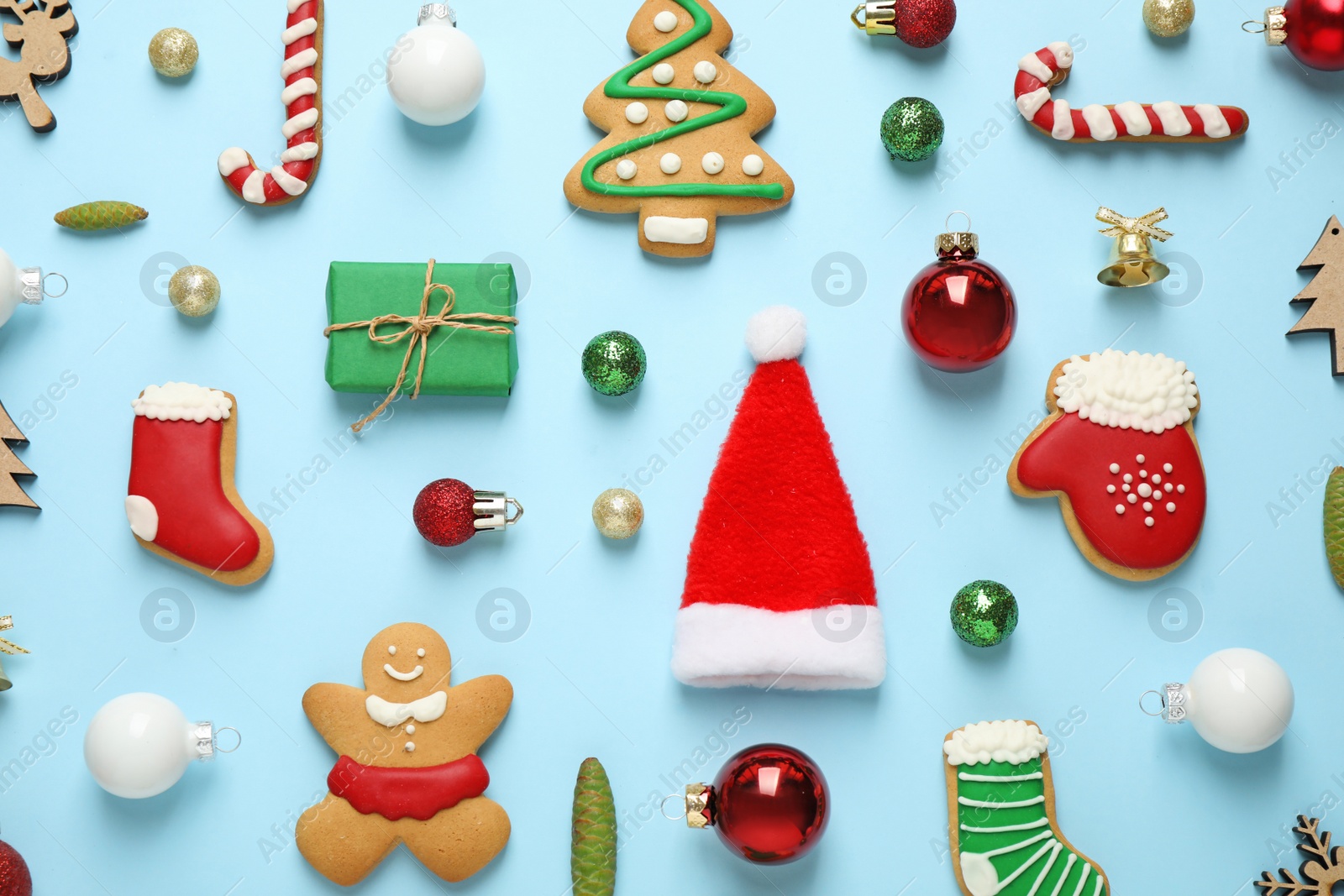 Photo of Flat lay composition with Christmas decorations on light blue background