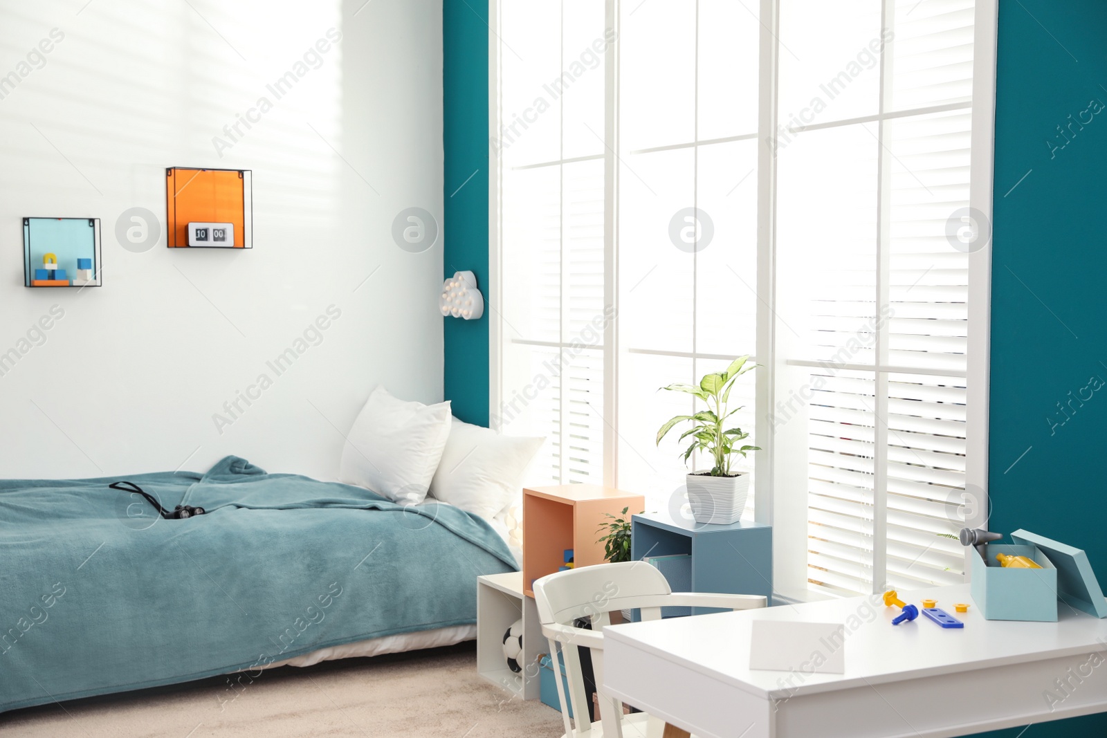 Photo of Modern child room interior with desk and comfortable bed