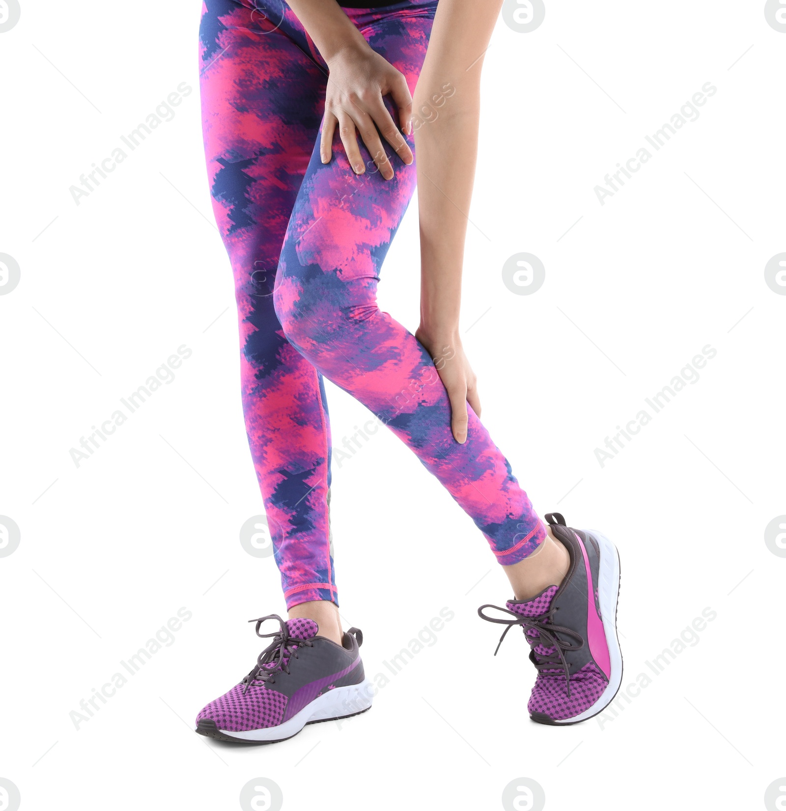 Photo of Young woman suffering from leg pain on white background, closeup