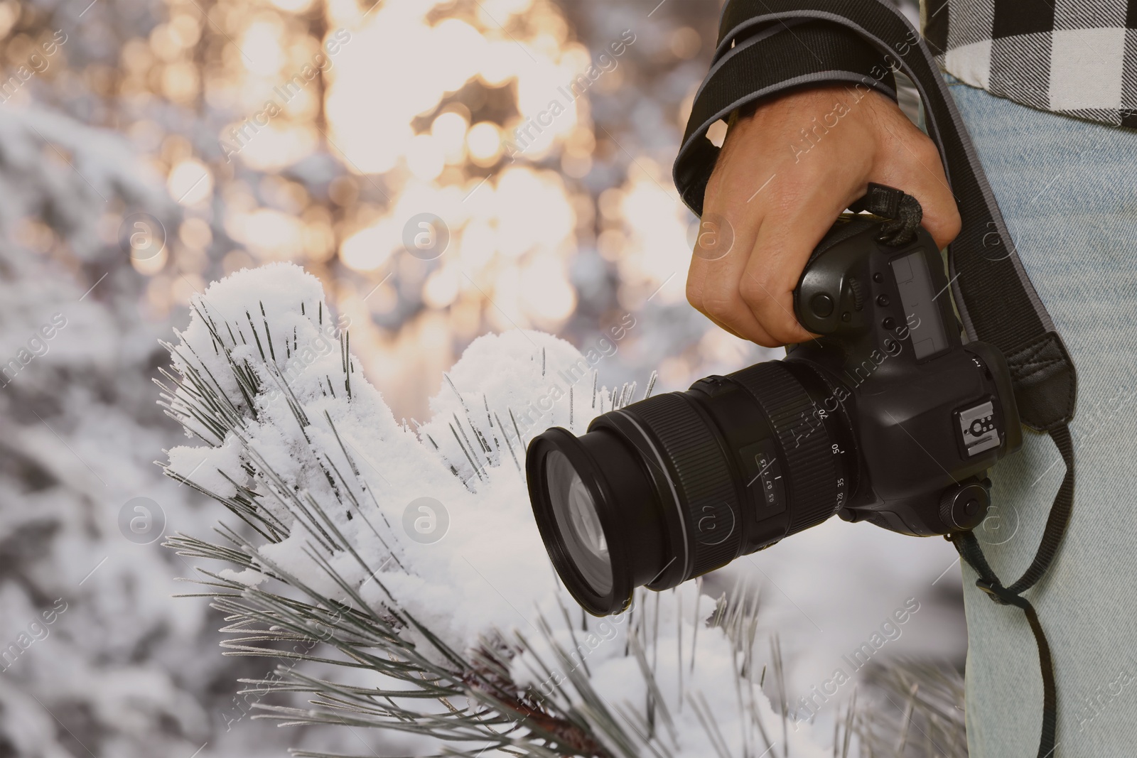 Image of Professional photographer with modern camera and blurred view of snowy forest, space for text