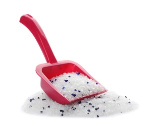 Photo of Red plastic scoop and cat litter isolated on white