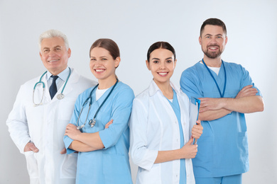 Photo of Group of doctors against light background. Medical service