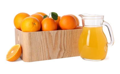 Photo of Fresh oranges in wooden crate and juice isolated on white