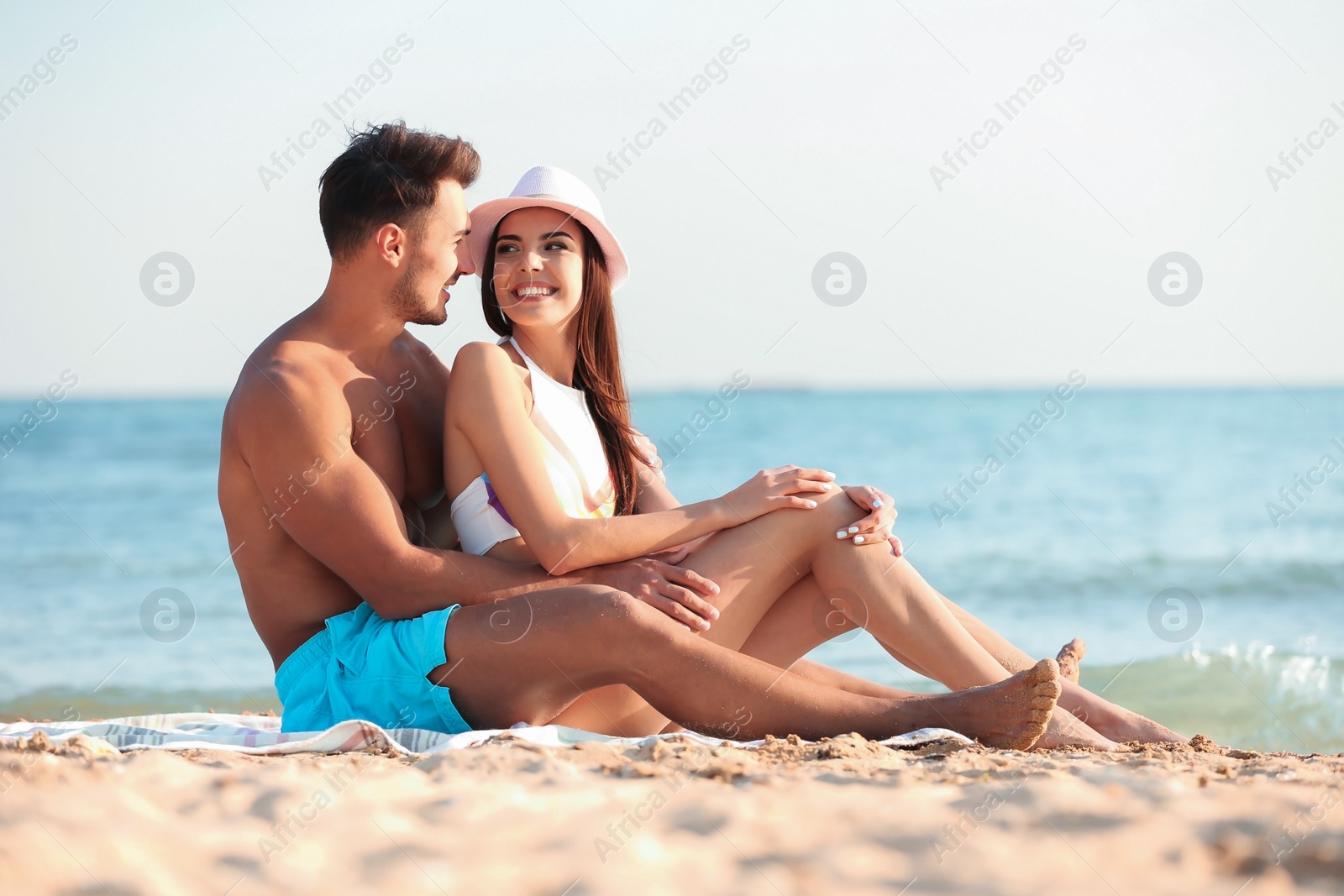 Photo of Happy young couple at beach on sunny day