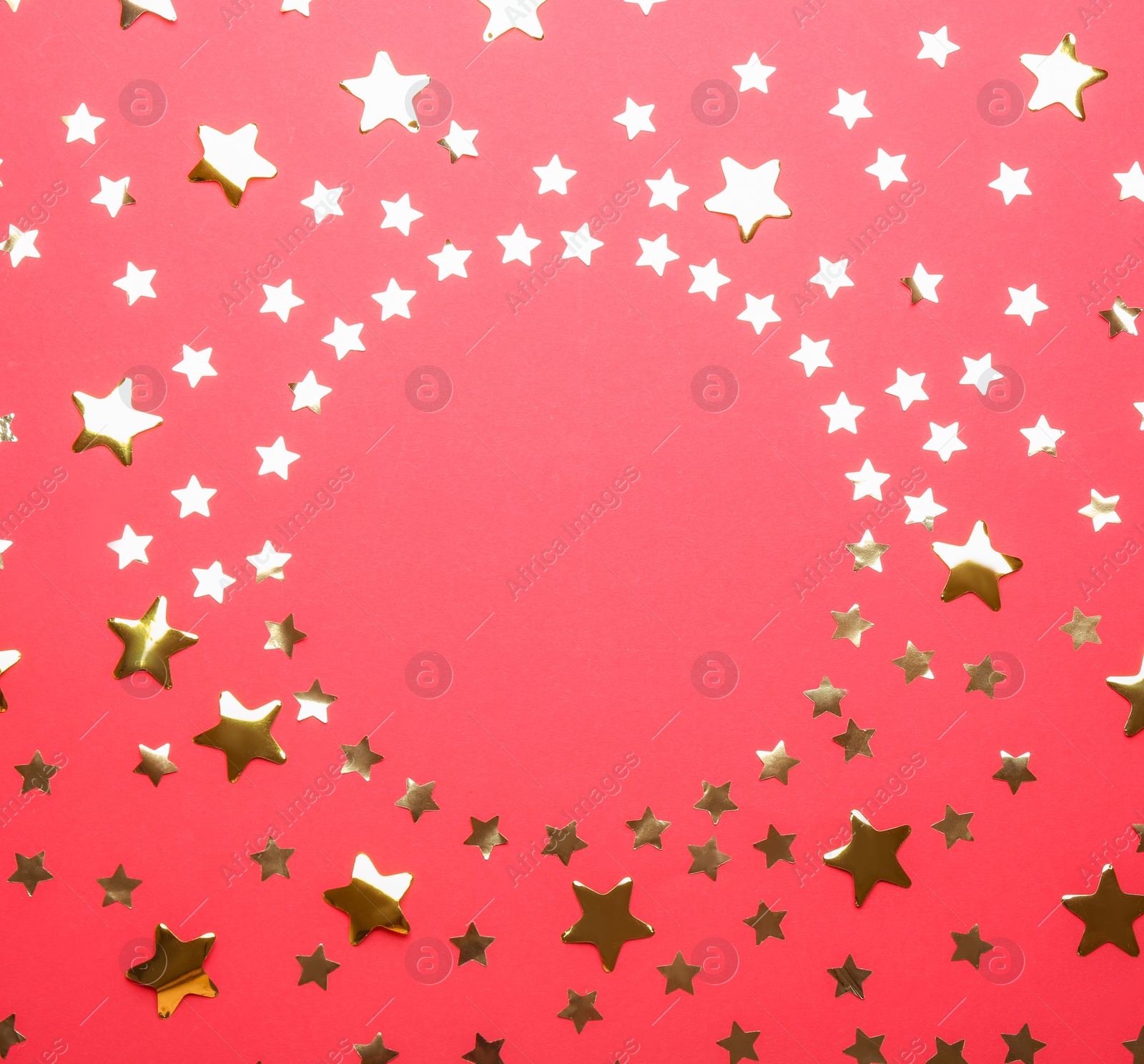 Photo of Frame made of confetti stars with space for text on red background, top view. Christmas celebration