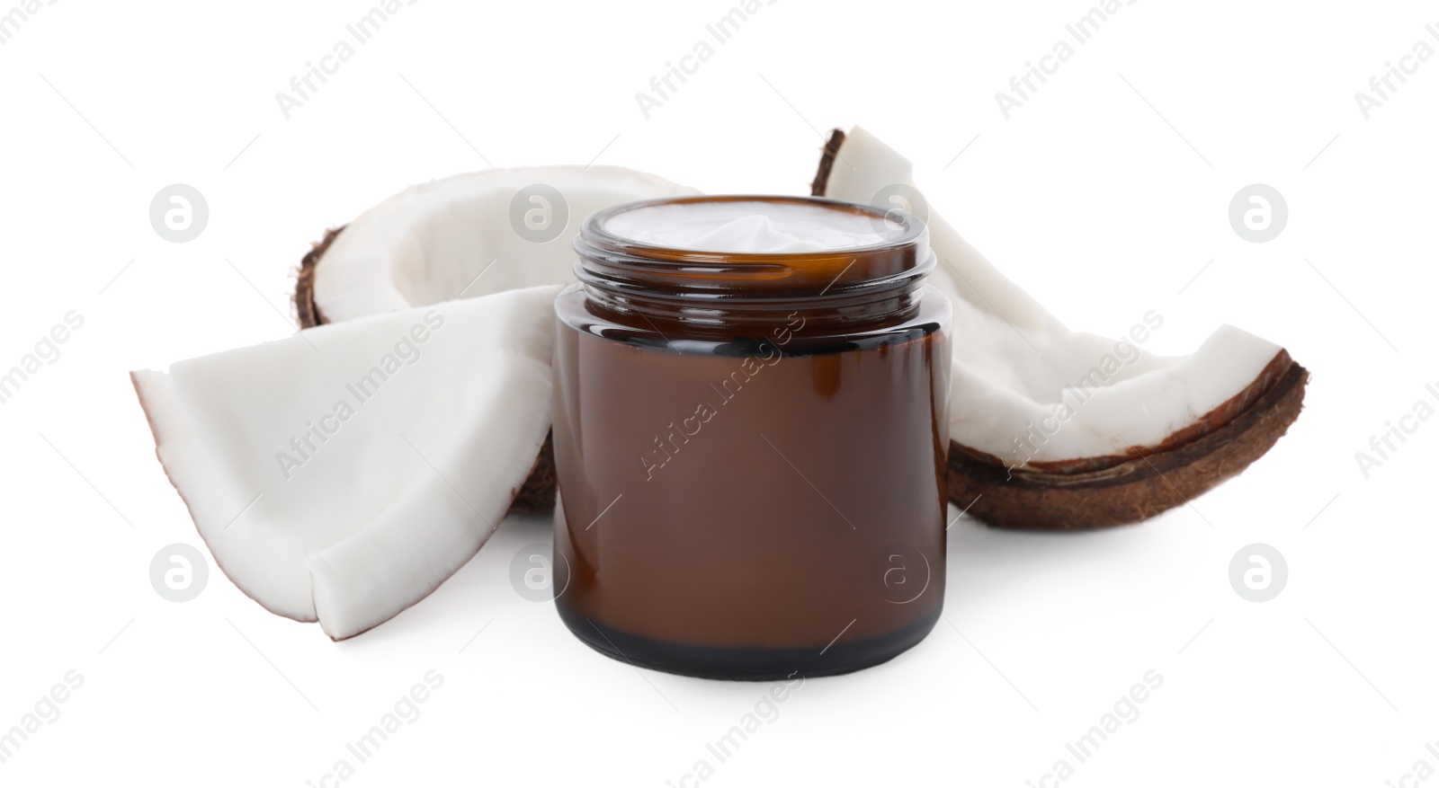 Photo of Jar of hand cream and coconut pieces on white background