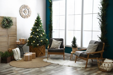 Photo of Beautiful interior with decorated Christmas tree in living room