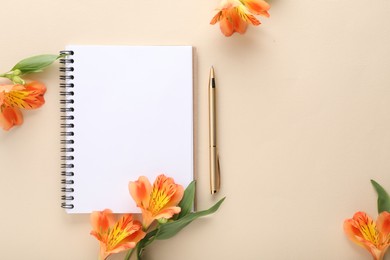 Guest list. Notebook, pen and beautiful flowers on beige background, flat lay. Space for text