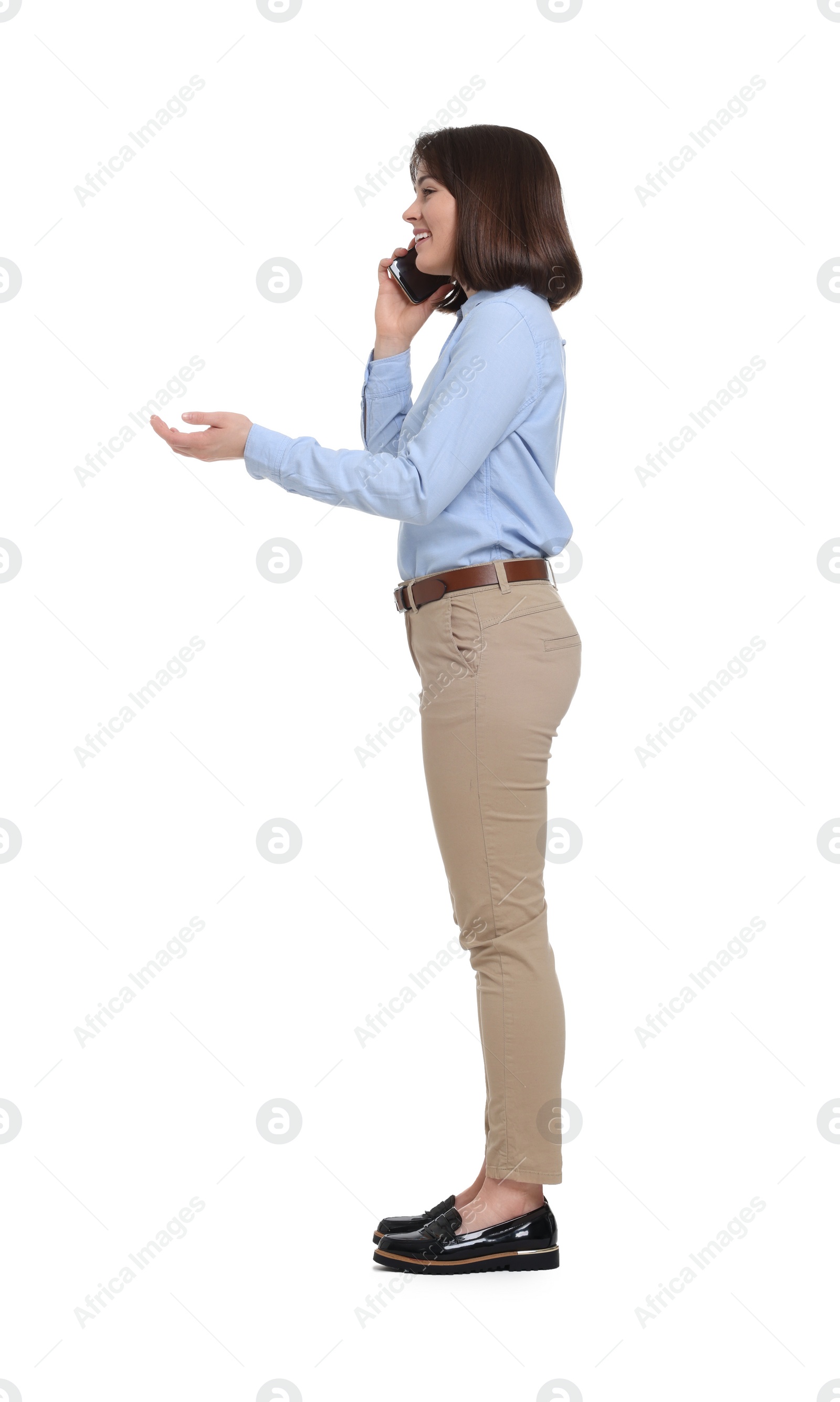 Photo of Happy businesswoman woman talking on smartphone against white background