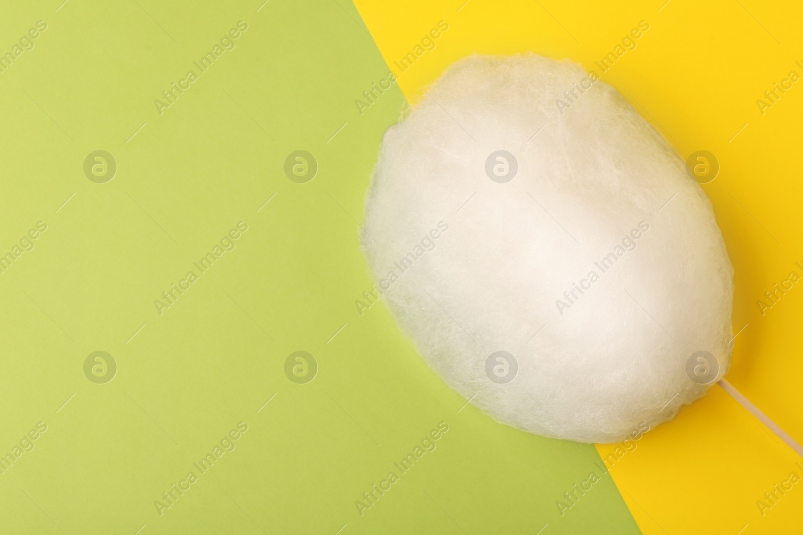 Photo of One sweet cotton candy on color background, top view. Space for text